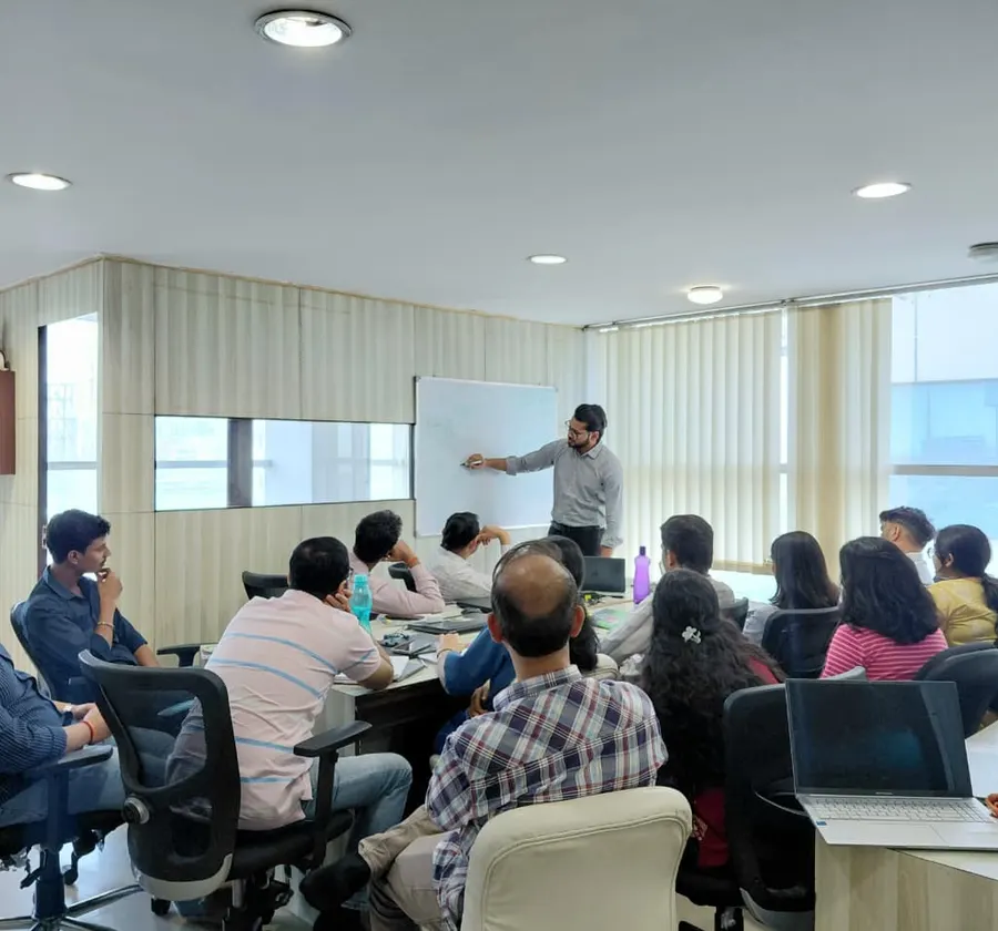 Engineers pair-working at a whiteboard session